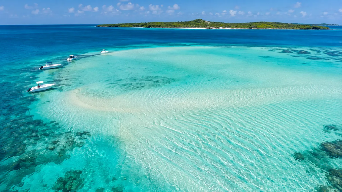 Aerial view of a shallow turquoise sandbar natural pool